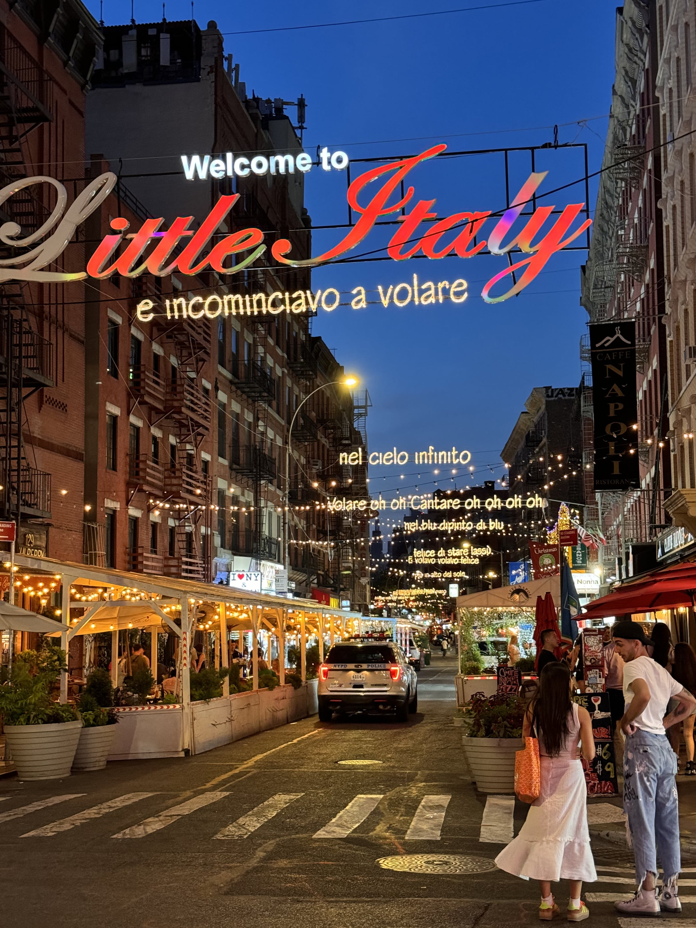 A Little Italy street strung with lights at night