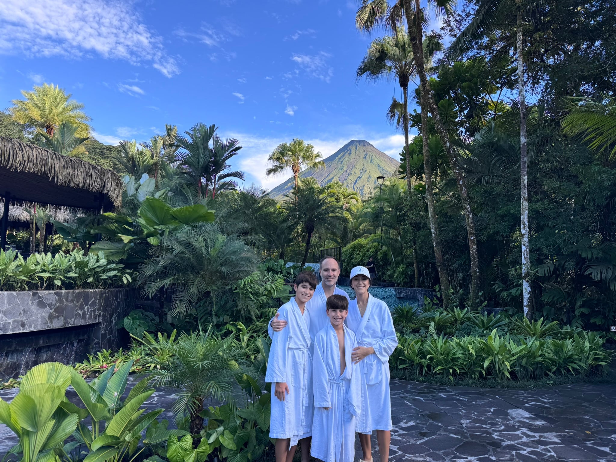 The family in robes at a tropical resort spa