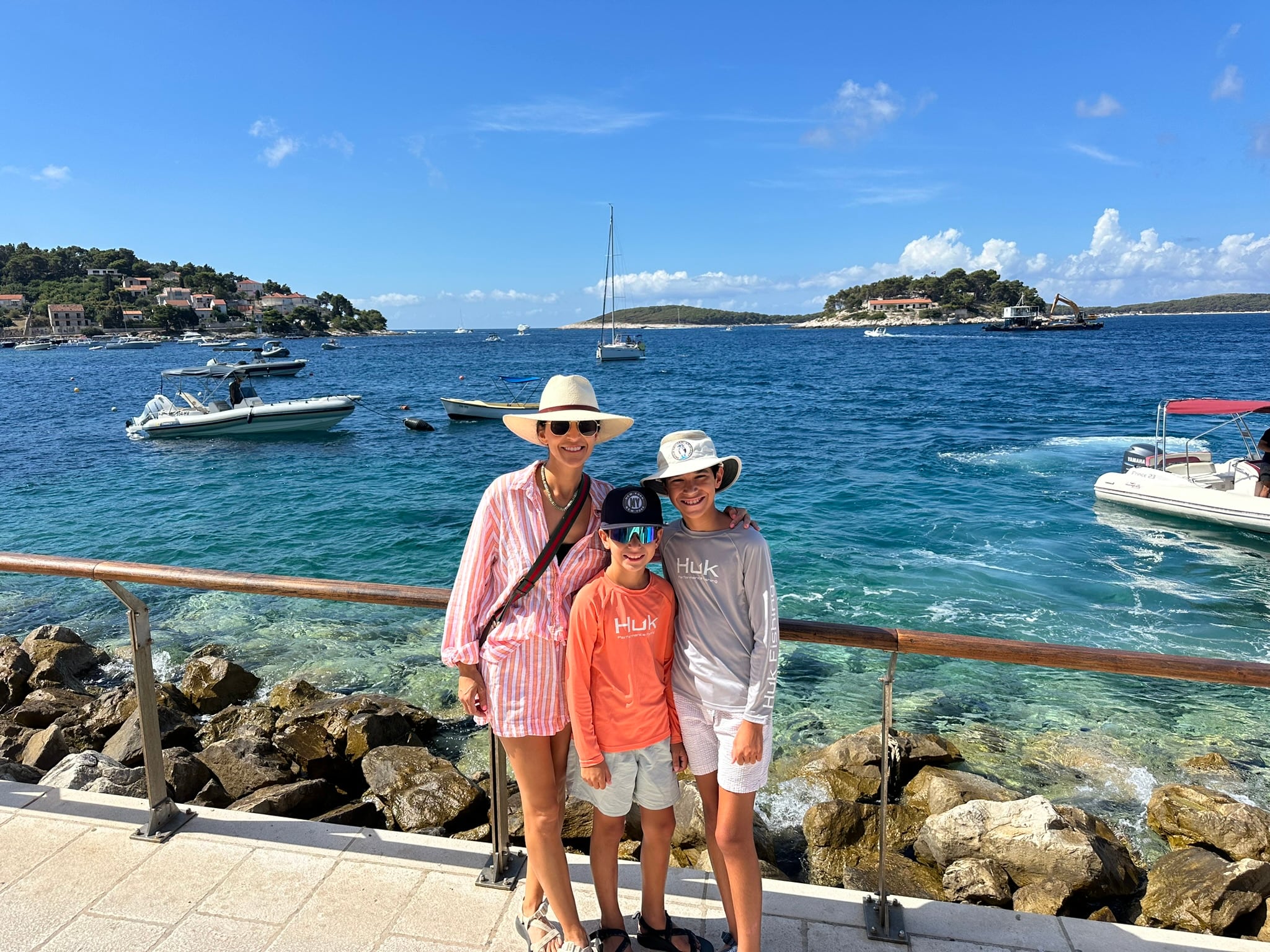Family on the rocks by the water in Croatia